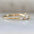 white half moon cut diamond with the tapered baguette sides in yellow gold