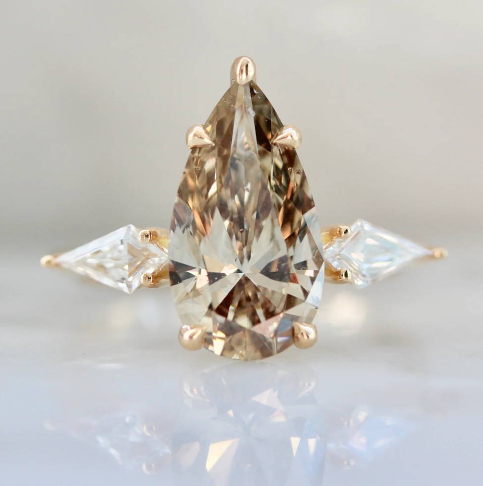 pear shaped champagne diamond ring with kite diamond side stones