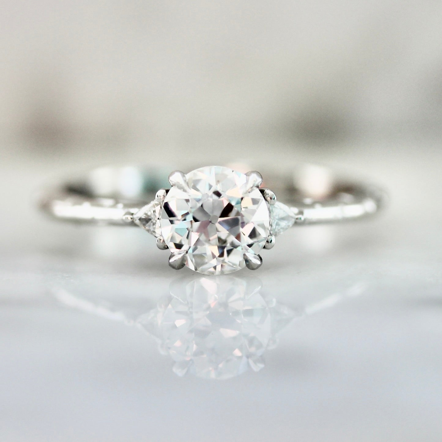 Old European cut diamond engagement ring with trillion side stones in a custom white gold setting by Gem Breakfast