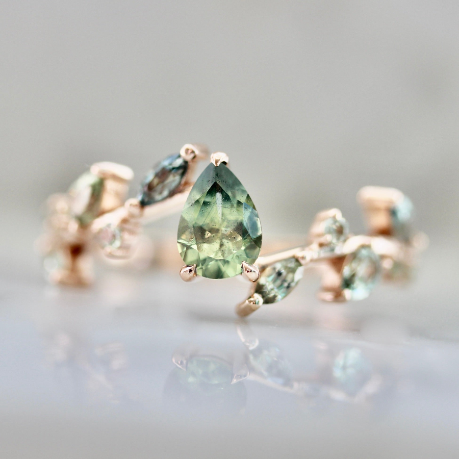 Custom nature inspired engagement ring with light green pear sapphire and pale green sapphire accents by Gem Breakfast