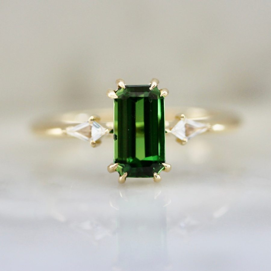 Emerald cut green tourmaline engagement ring with kite diamond side stones in a custom design by Gem Breakfast