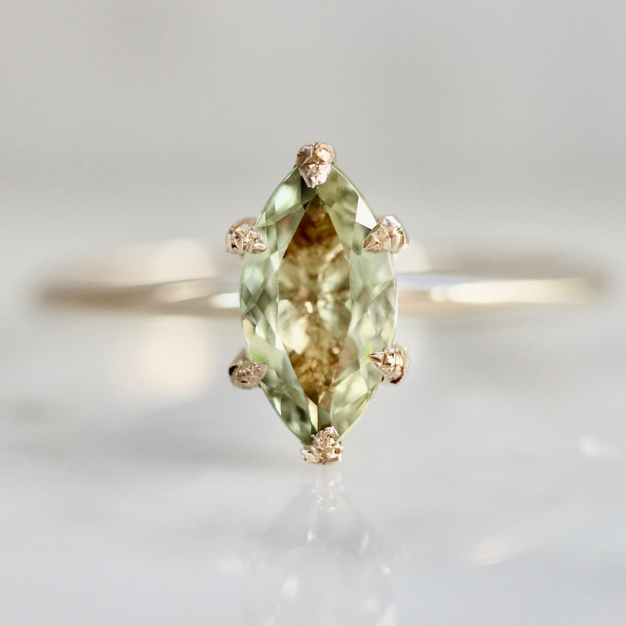 Custom engagement ring with marquise cut green chrysoberyl and hand-engraved prongs by Gem Breakfast