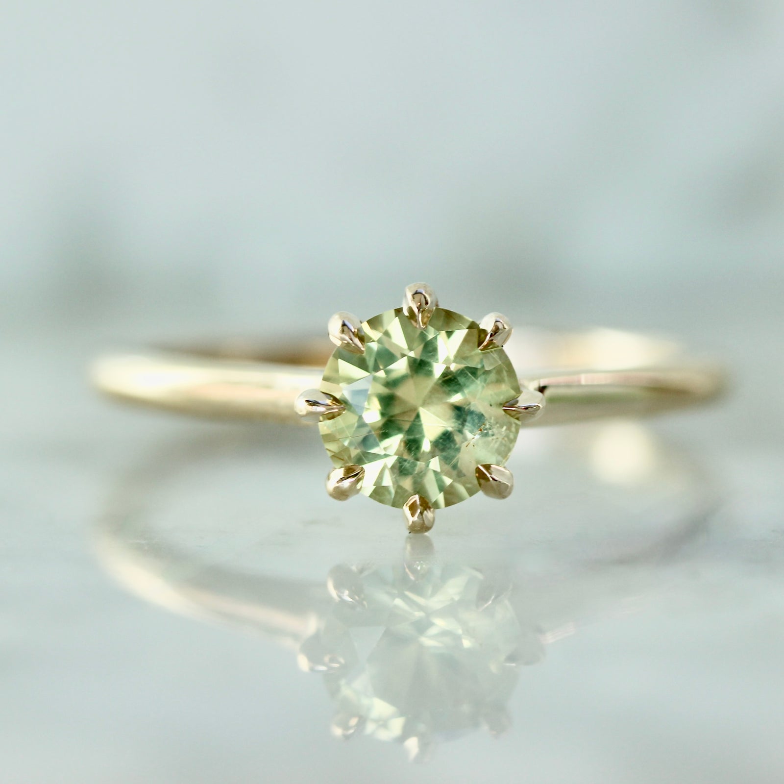 Custom engagement ring with round cut green chrysoberyl in yellow gold by Gem Breakfast