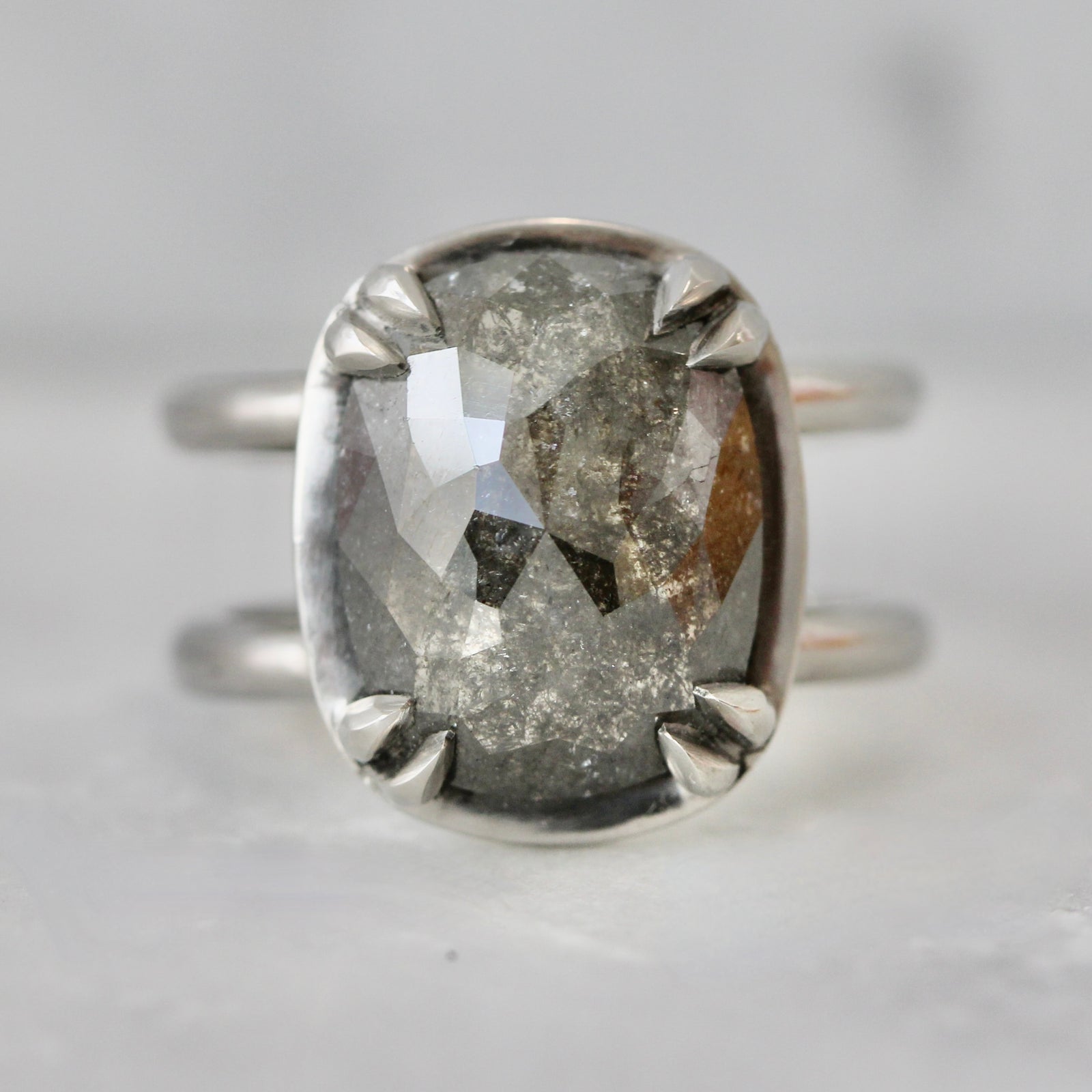 Custom engagement ring with cushion cut salt and pepper diamond in a platinum split shank setting by Gem Breakfast