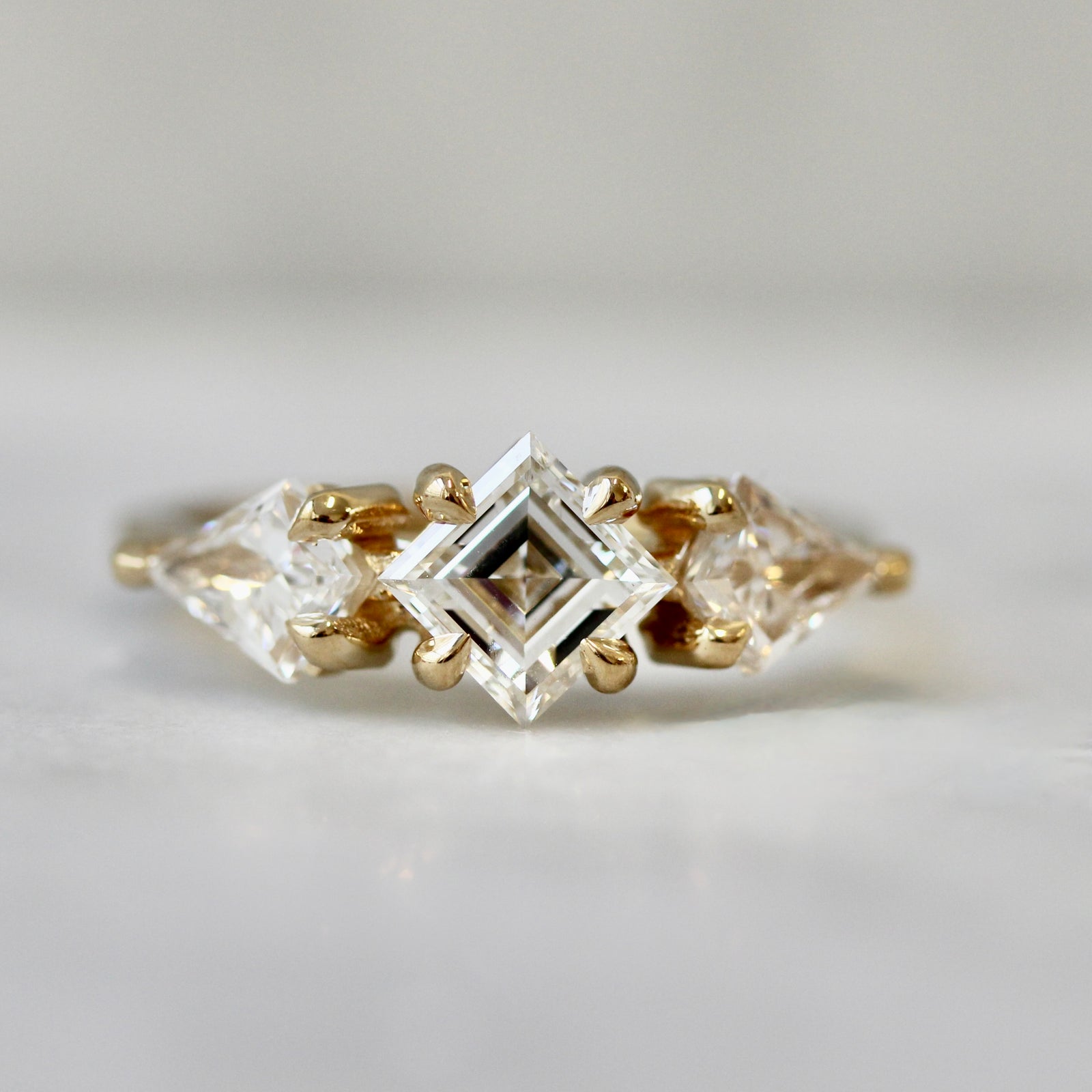 Carré cut diamond custom engagement ring with kite diamond side stones by Gem Breakfast