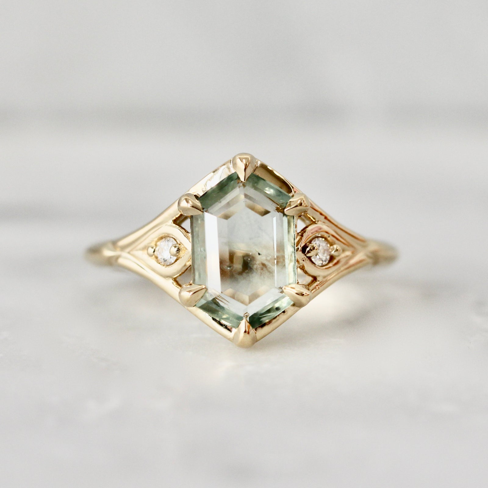Hexagon cut light green Montana sapphire engagement ring in a vintage inspired custom setting by Gem Breakfast