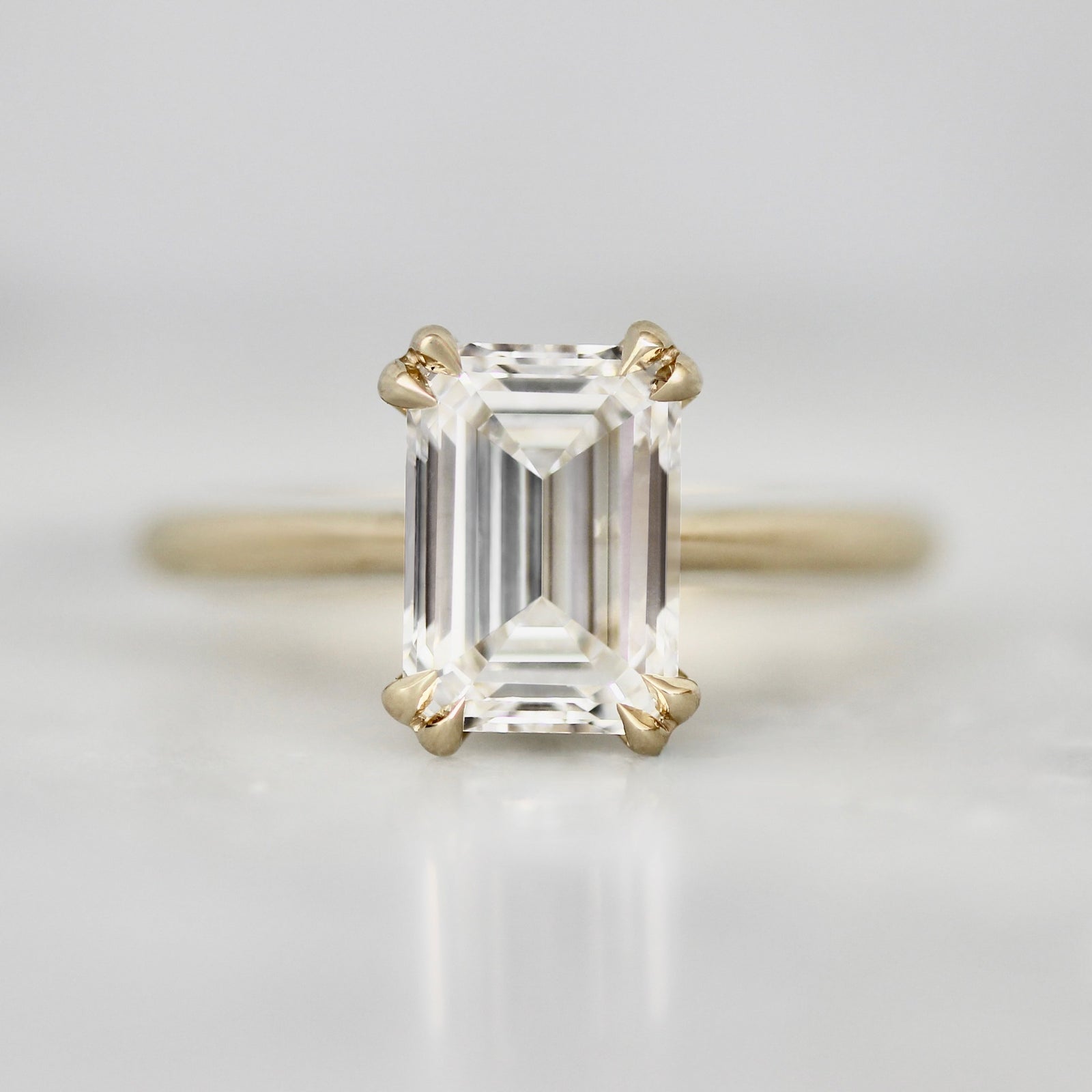 Lab grown diamond emerald cut custom engagement ring in 14k yellow gold by Gem Breakfast
