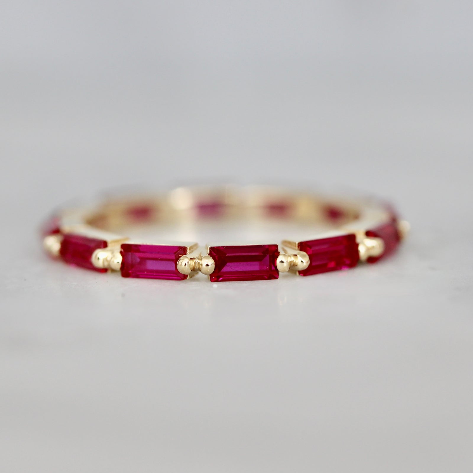 Custom baguette cut ruby ring in eternity setting by Gem breakfast