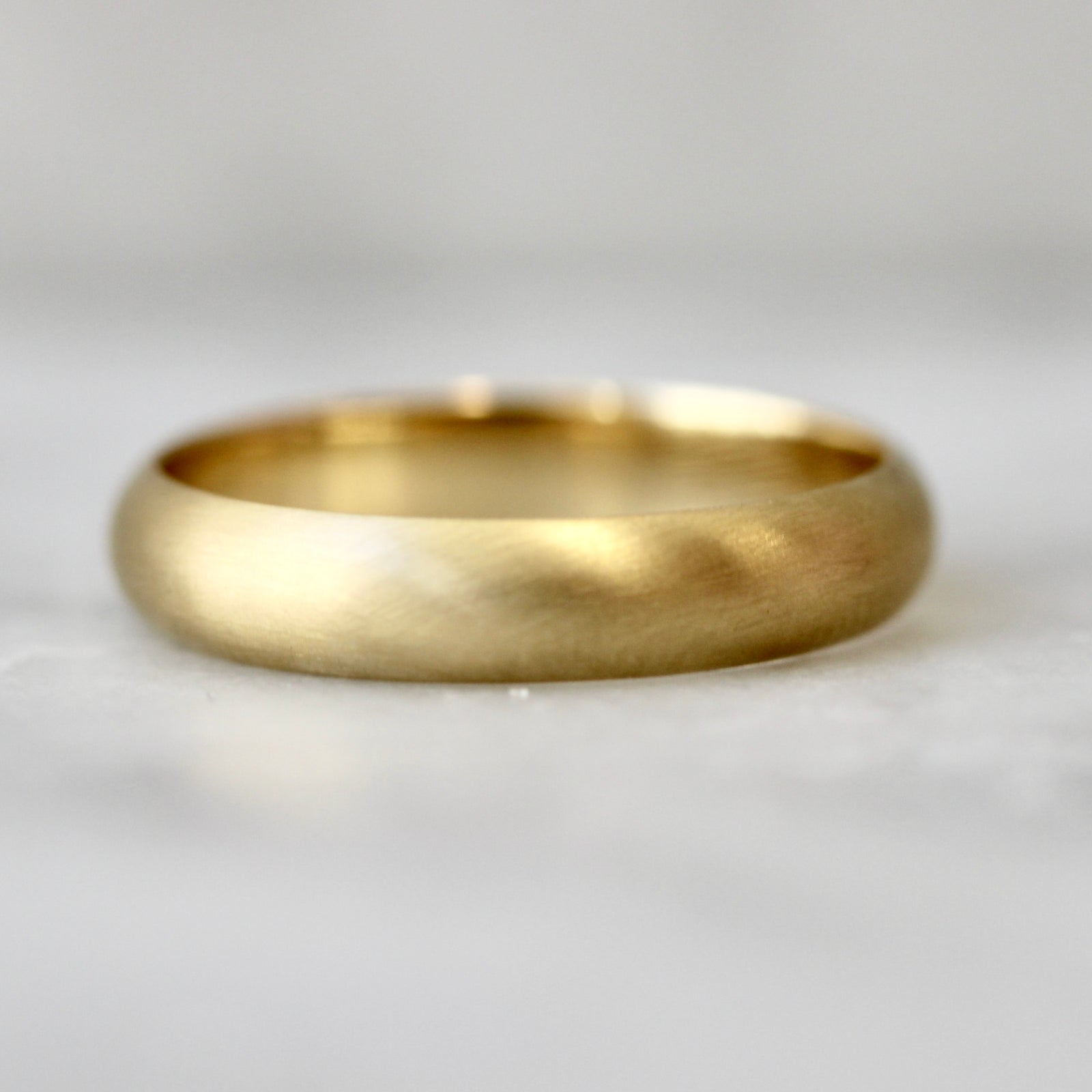 Custom matte gold men’s wedding band by Gem Breakfast 