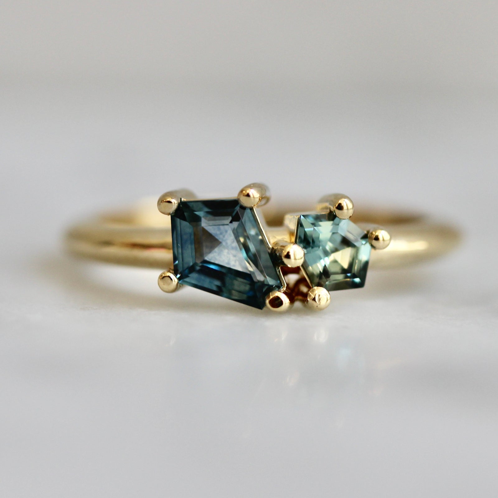 Two-tone geometric green sapphire custom engagement ring in a Toi et Moi setting by Gem Breakfast