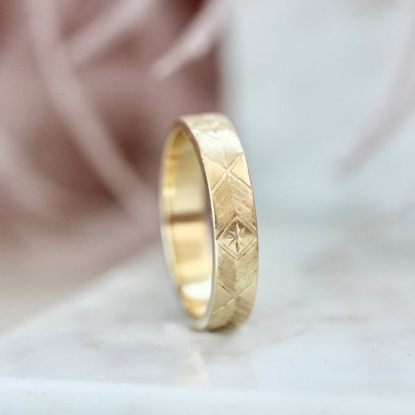 Starburst engraved gold wedding band