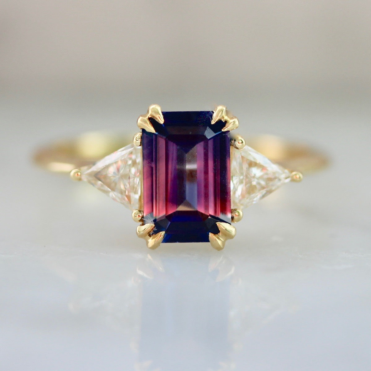 Blue & Pink Emerald Cut Sapphire Ring In 18k Yellow Gold With Trillion Cut Side Diamonds 1994