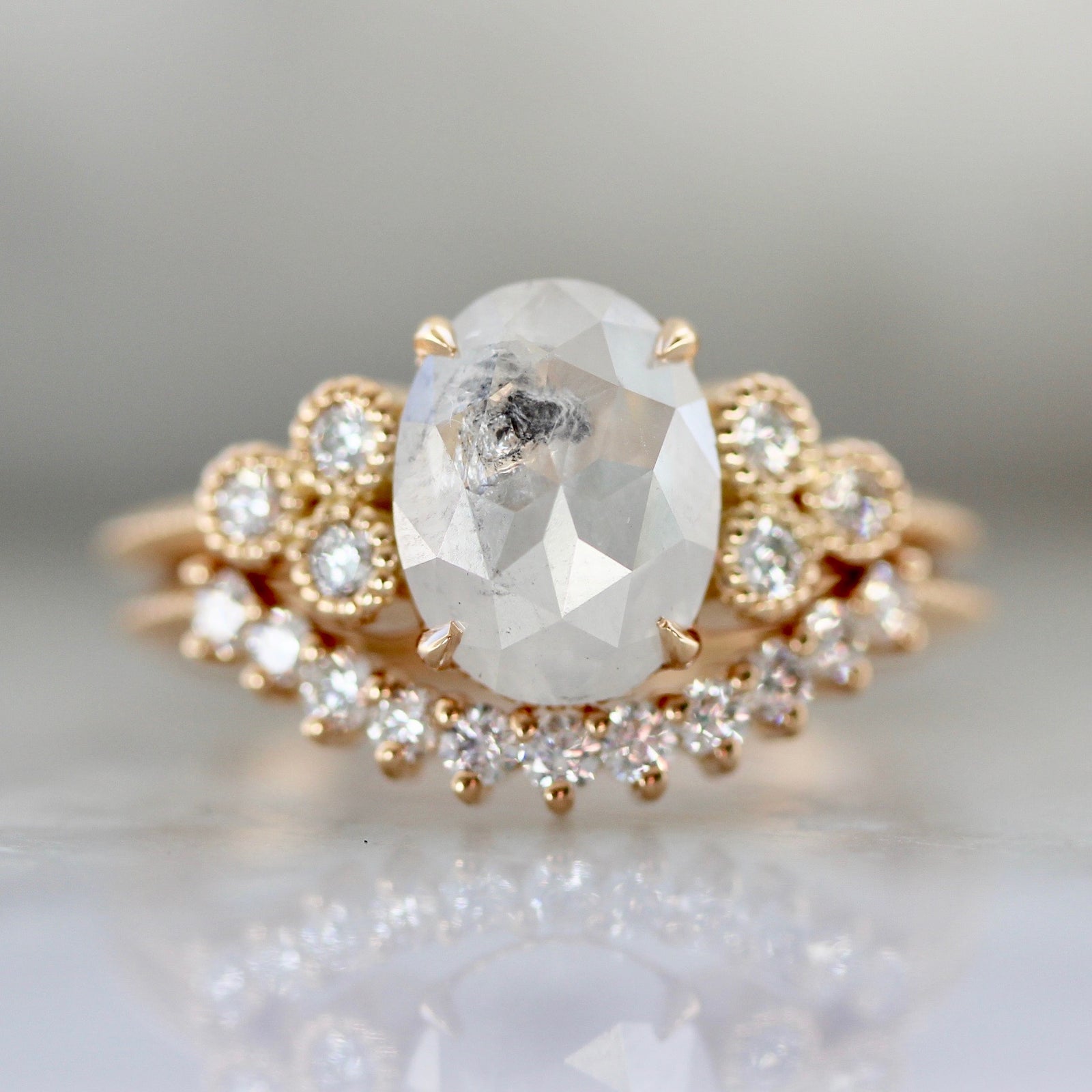 Oval Cut Icey Salt & Pepper Diamond Ring with three stone cluster diamond and milgrain and matching curved wedding band in 18k Peach Gold - Gem Breakfast Custom Ring