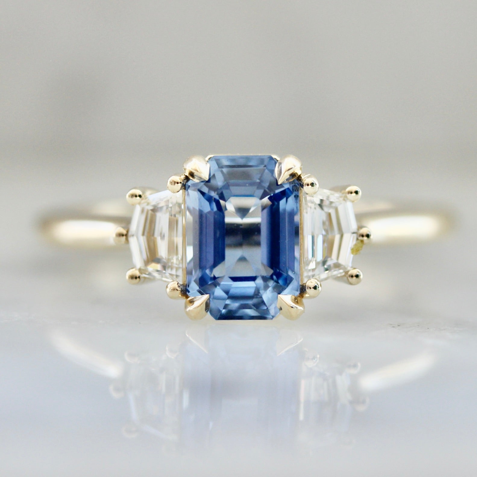 4133 Blue Emerald Cut Sapphire with Cadis Cut Side Diamonds In Yellow Gold