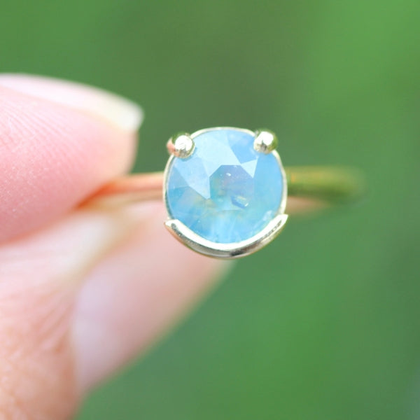 Poliwhirl Teal Round Brilliant Cut Opalescent Sapphire Ring