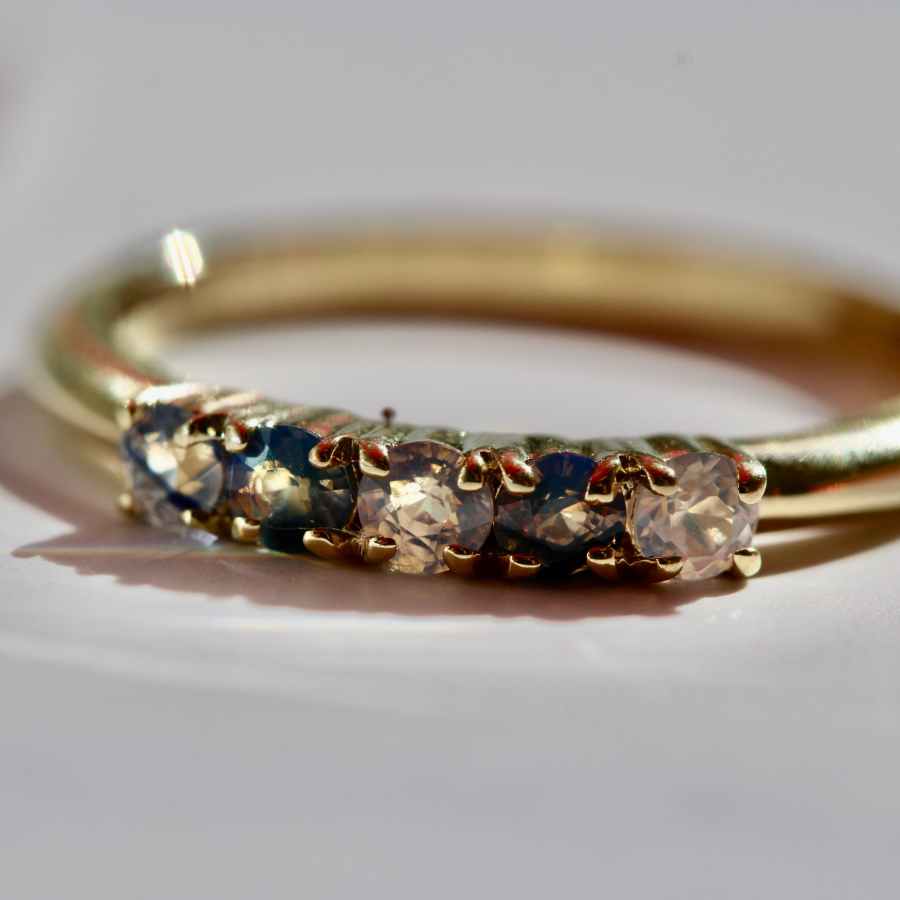 
            Round Cut Opalescent Sapphire Band