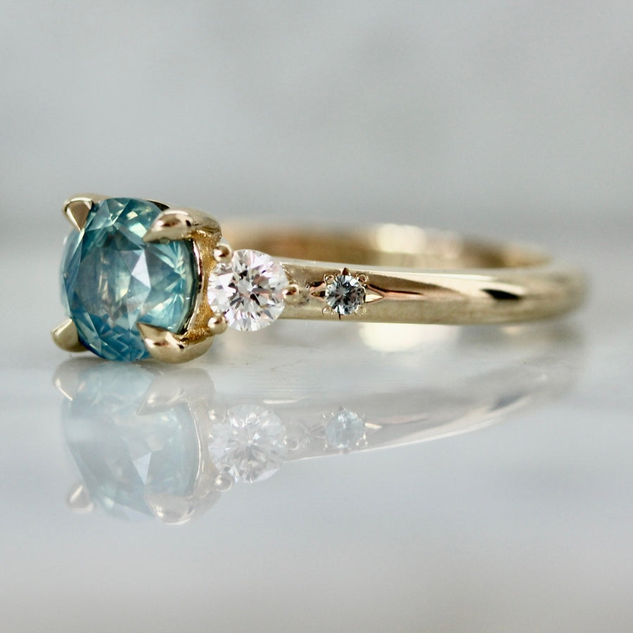 teal round brilliant cut sapphire ring