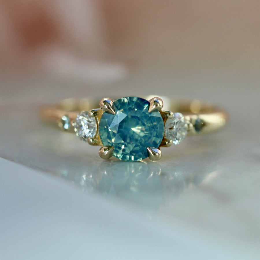 
            teal round brilliant cut sapphire ring