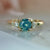 teal round brilliant cut sapphire ring