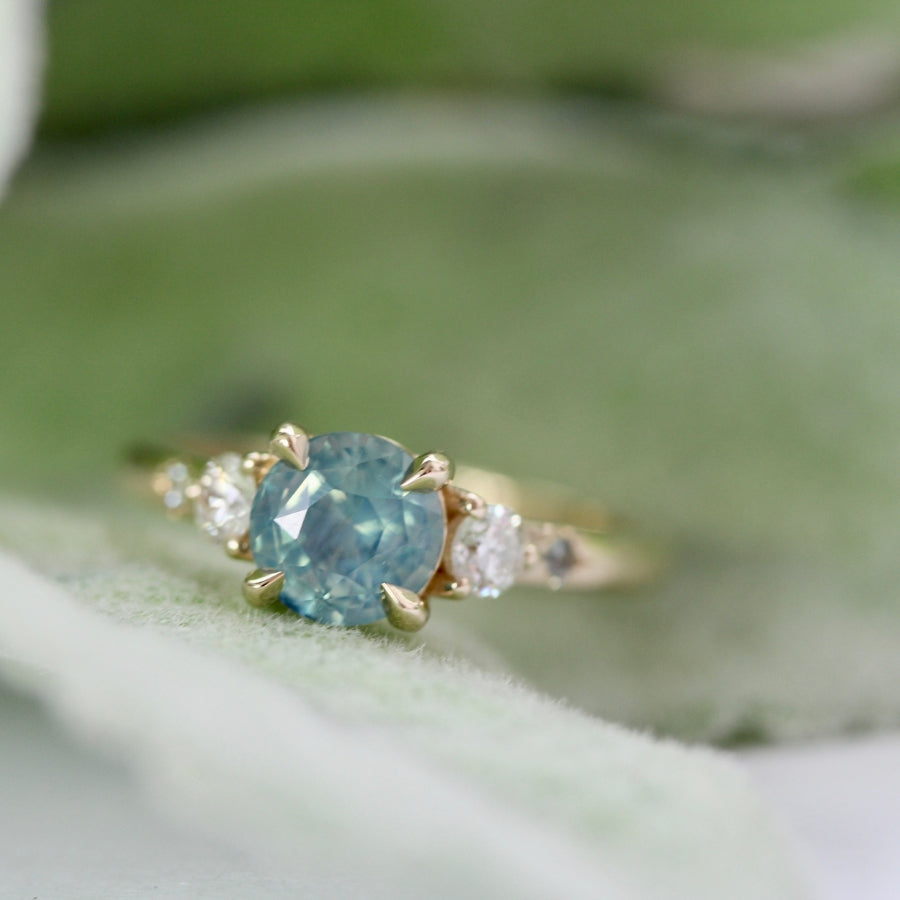 
            teal round brilliant cut sapphire ring