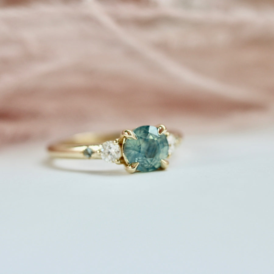 
            teal round brilliant cut sapphire ring