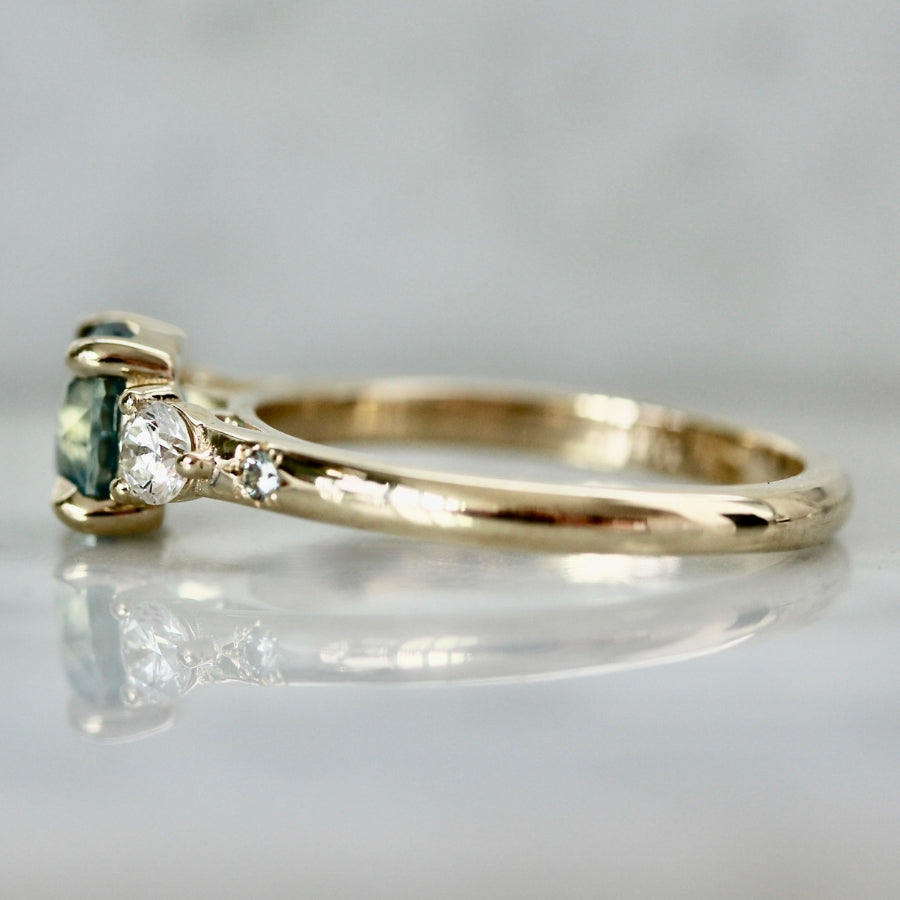 
            teal round brilliant cut sapphire ring