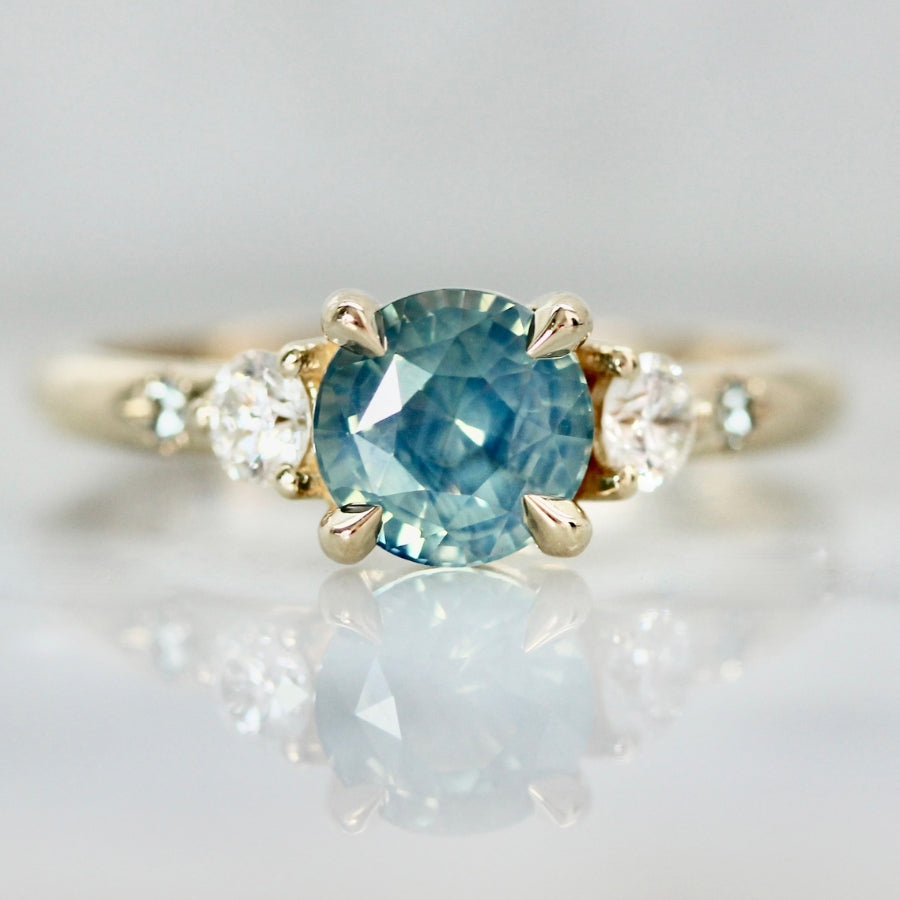 teal round brilliant cut sapphire ring