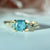 teal round brilliant cut sapphire ring