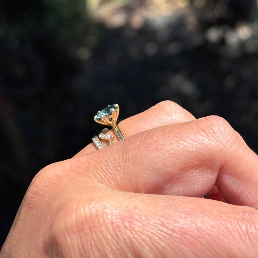teal round cut sapphire ring