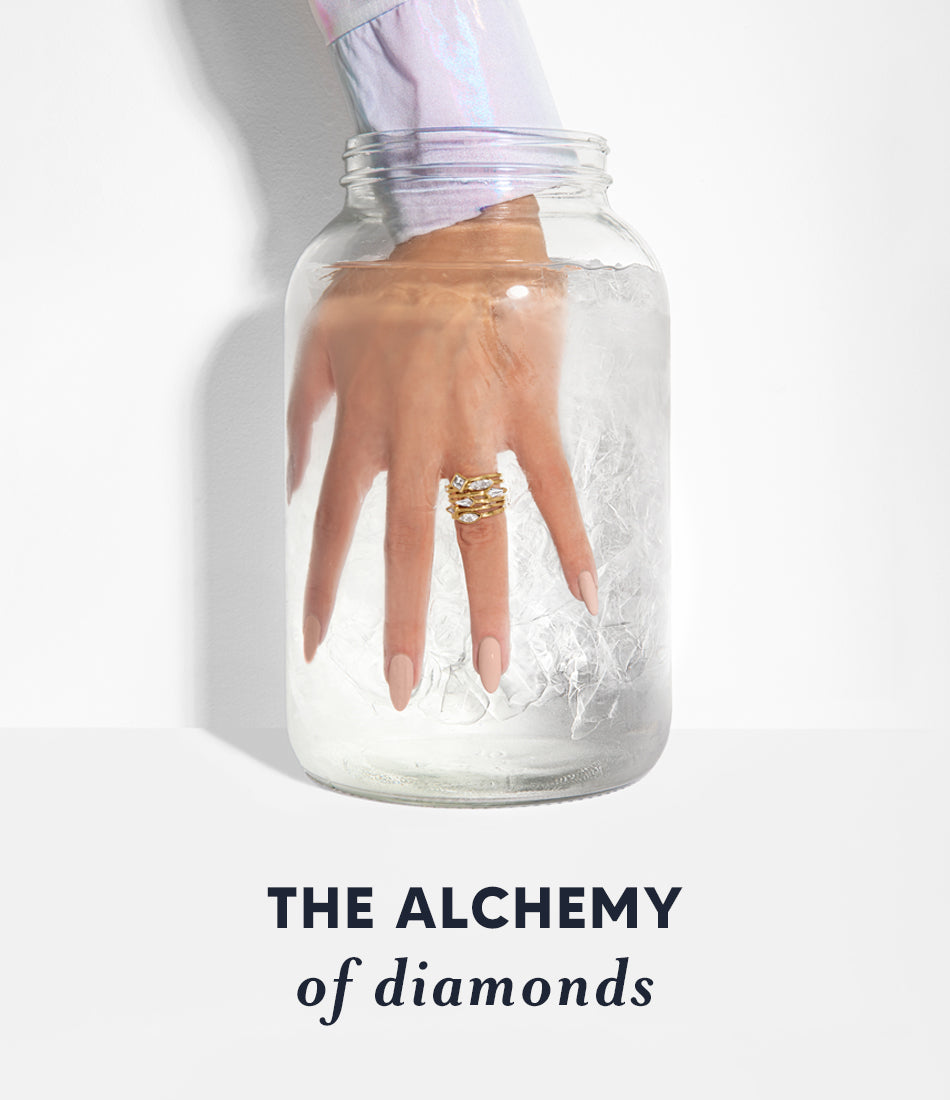 the alchemy of diamonds woman's hand in glass jar with water and diamonds