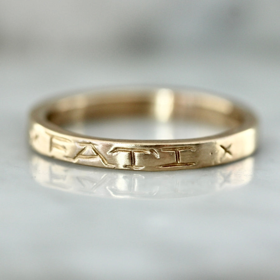 
            amor fati engraved gold band