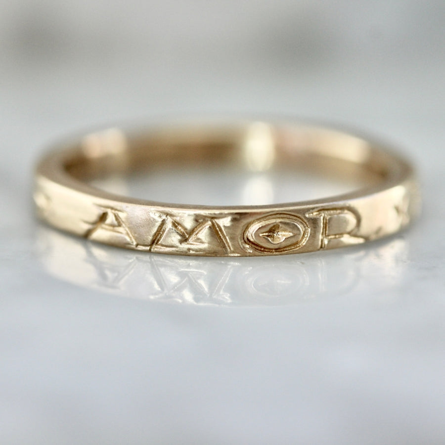 
            amor fati engraved gold band