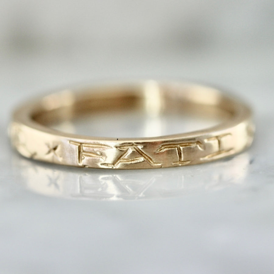 
            amor fati engraved gold band