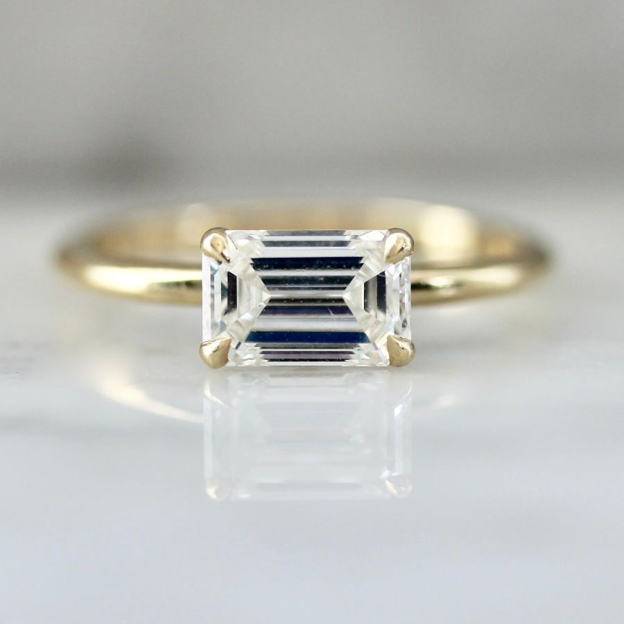Emerald cut diamond engagement ring in an east-west custom setting by Gem Breakfast