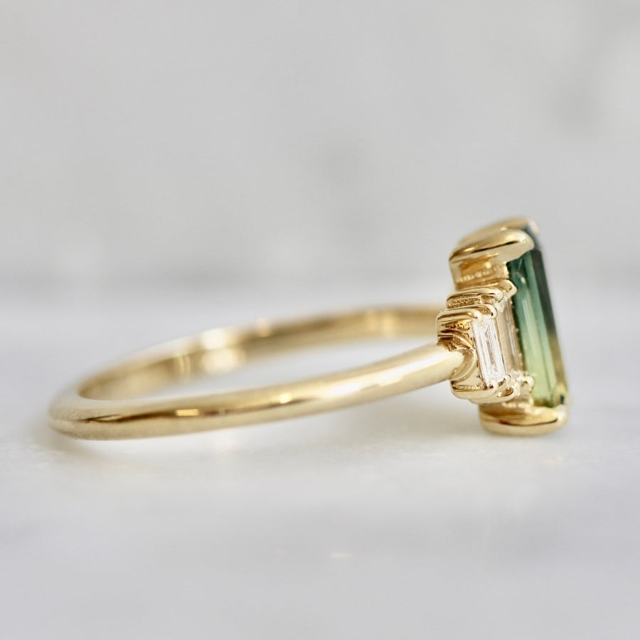 
            green-yellow emerald cut sapphire ring