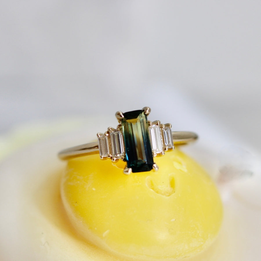 
            green-yellow emerald cut sapphire ring