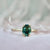 green oval sapphire engagement ring