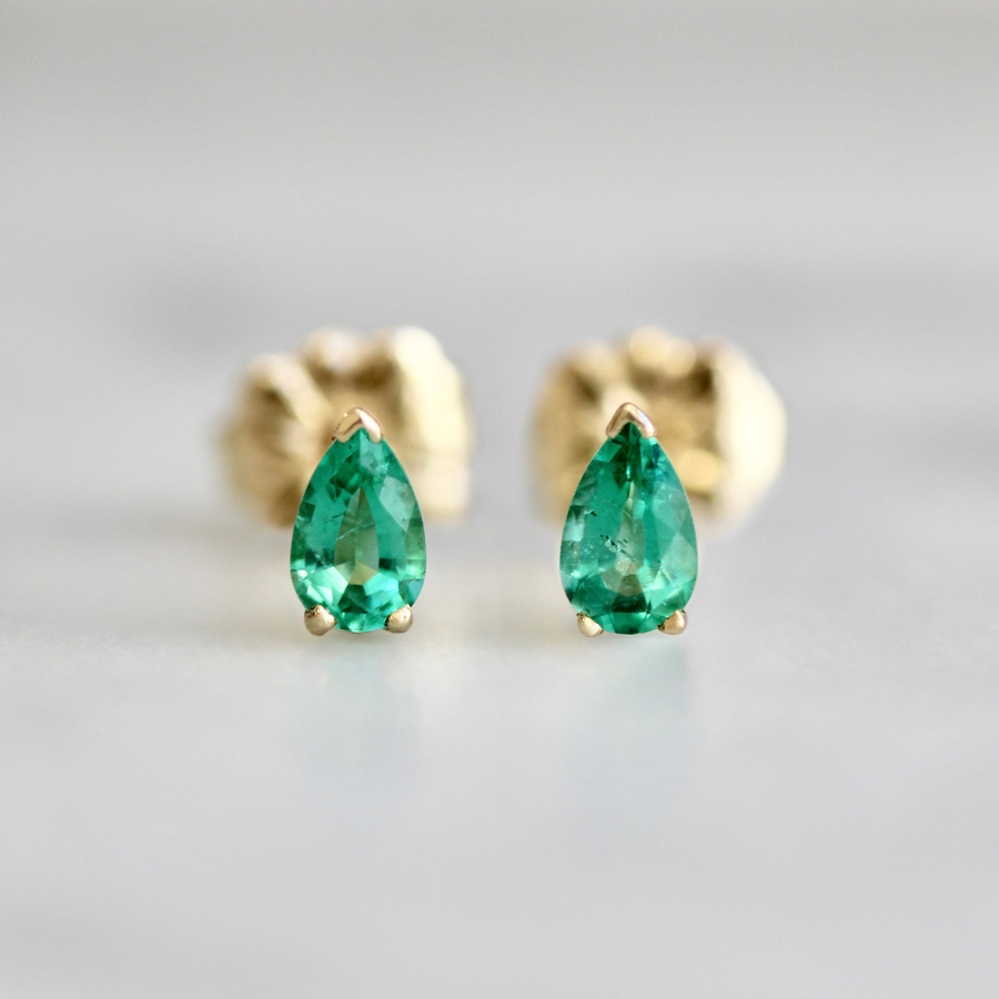 
            pear cut emerald earrings.