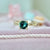 teal round sapphire engagement ring