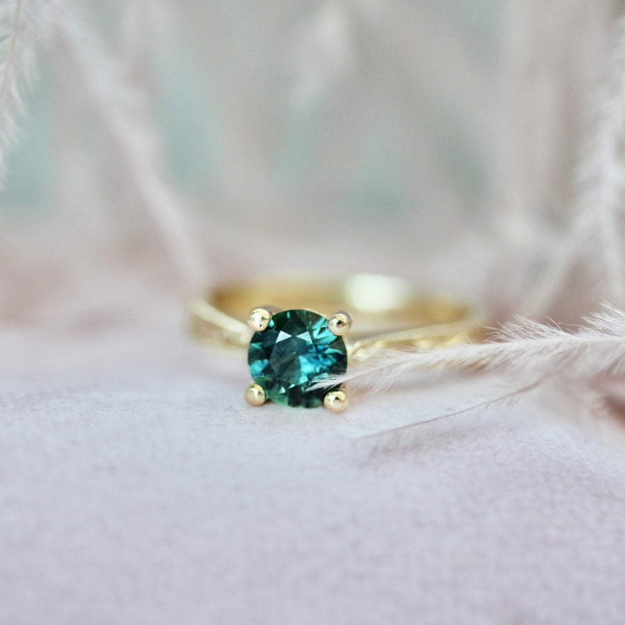 
            teal round sapphire ring