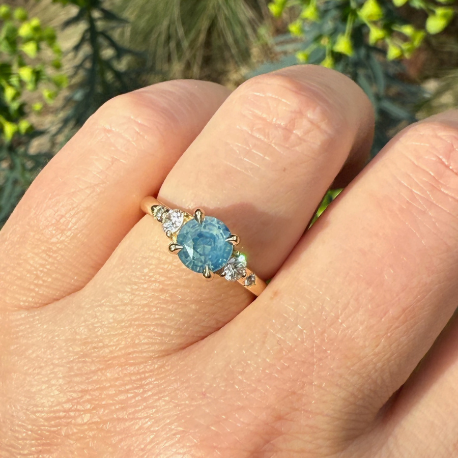 
            teal round brilliant cut sapphire ring