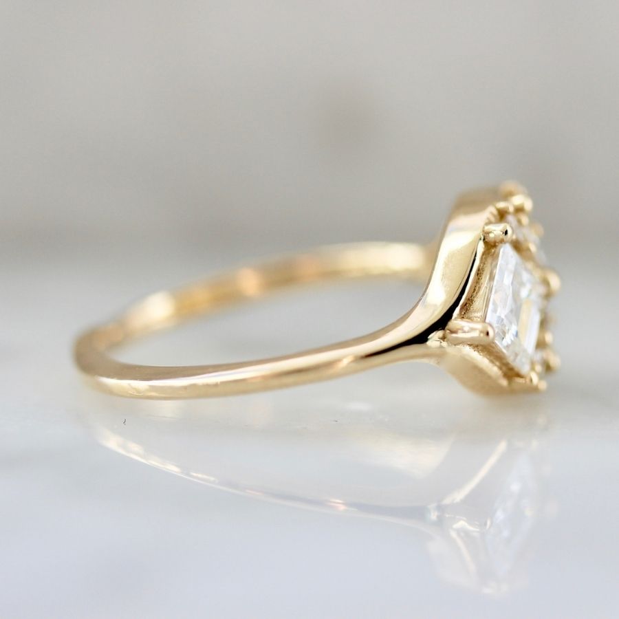 two white carre cut diamonds with six smaller white carre cut diamonds in yellow gold