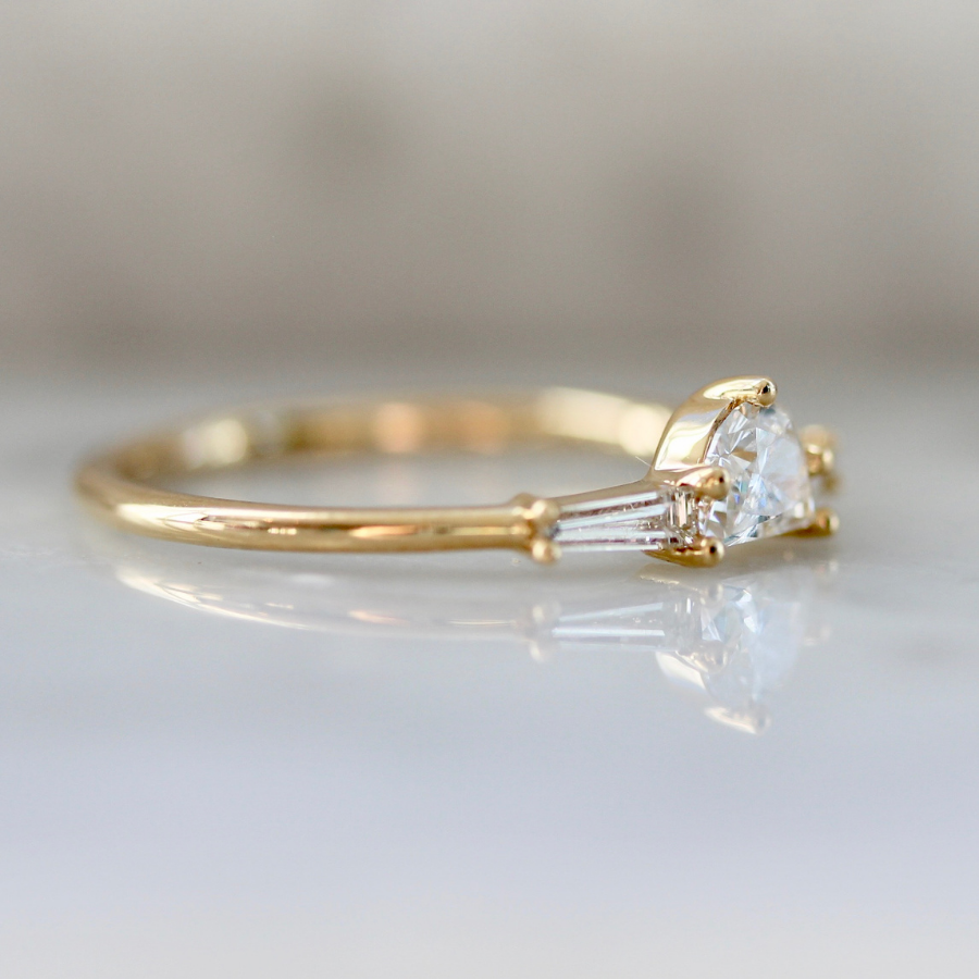 
            white half moon cut diamond with the tapered baguette sides in yellow gold