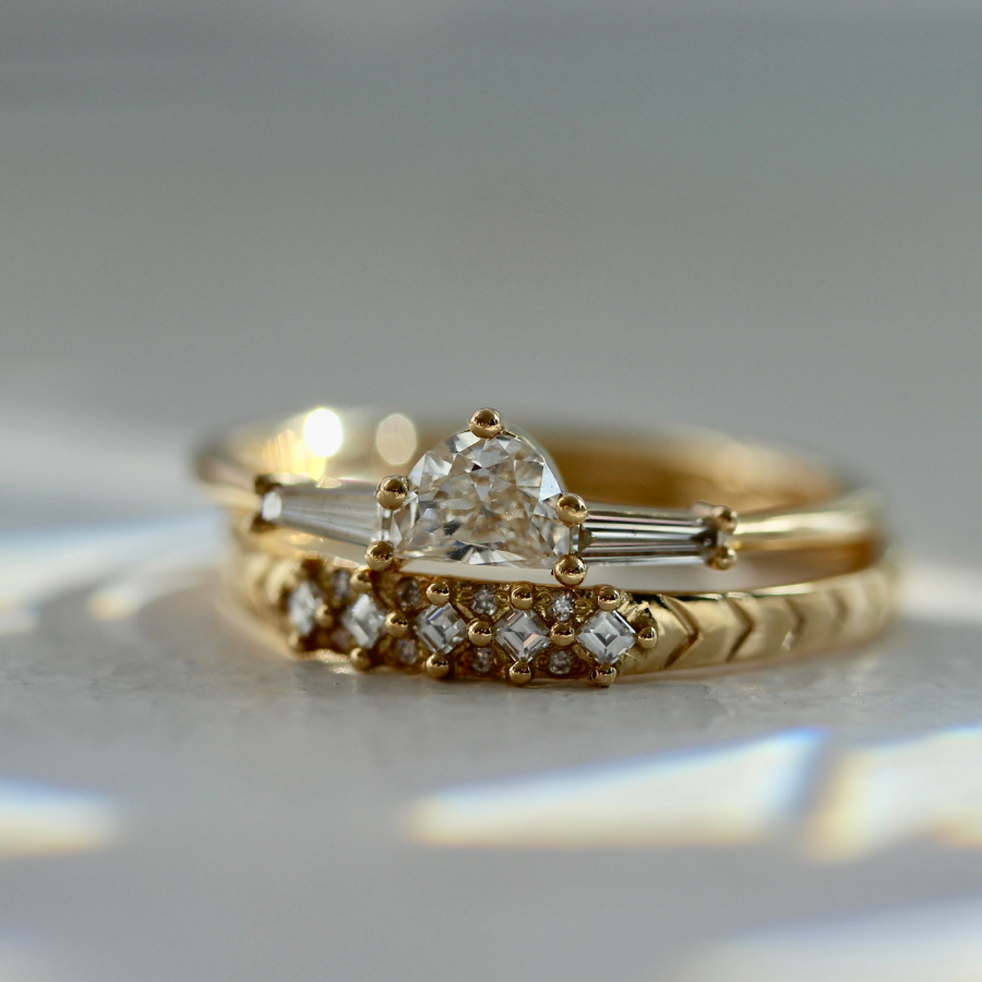 white half moon cut diamond with the tapered baguette sides in yellow gold