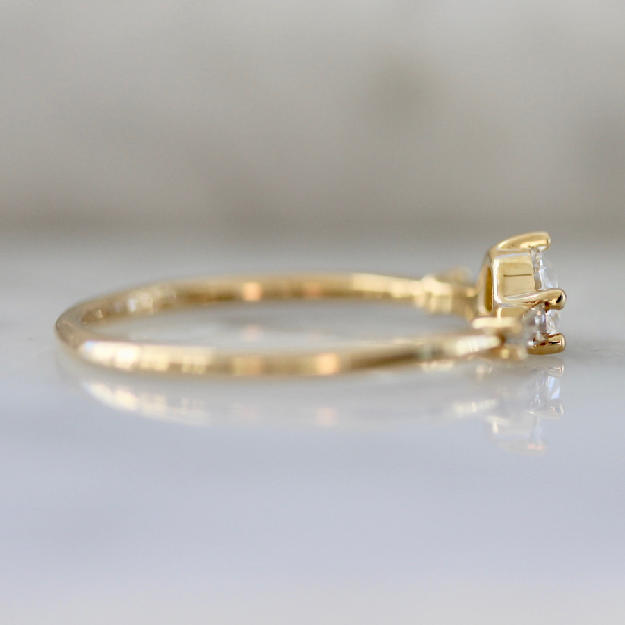 
            white half moon cut diamond with the tapered baguette sides in yellow gold