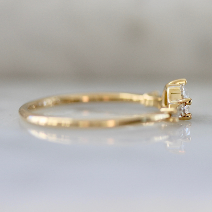white half moon cut diamond with the tapered baguette sides in yellow gold