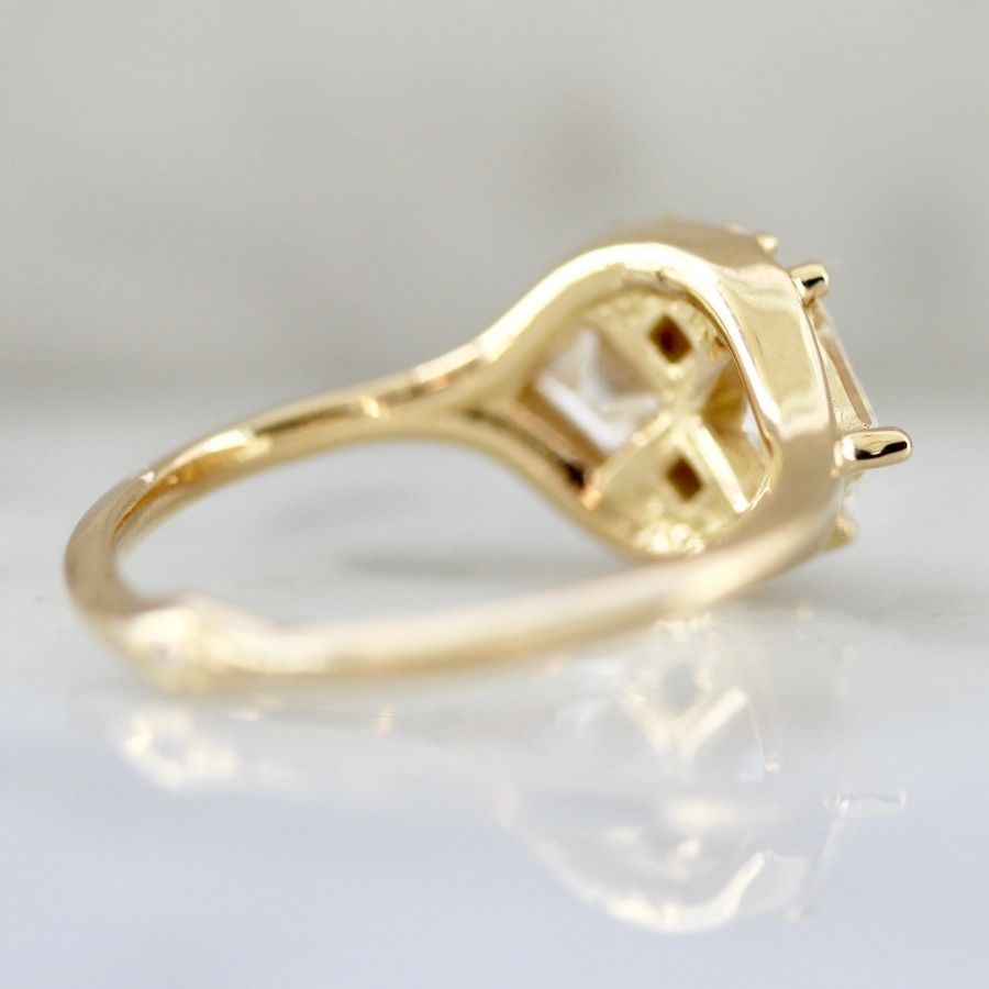 two white carre cut diamonds with six smaller white carre cut diamonds in yellow gold