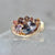 Heart in Hand Purple-Peach Oval Cut Sapphire Ring