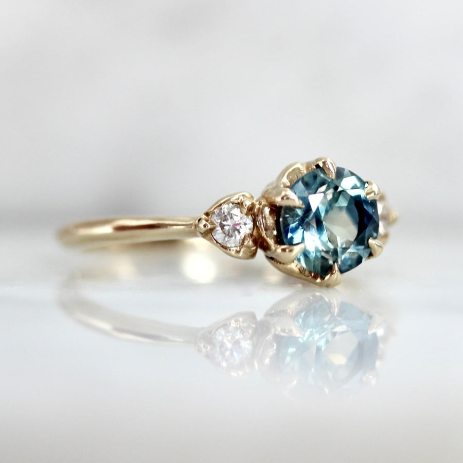 
            Shockwave Teal Round Brilliant Cut Sapphire Ring